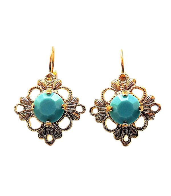 A pair of earrings with gold and turquoise colored stones.