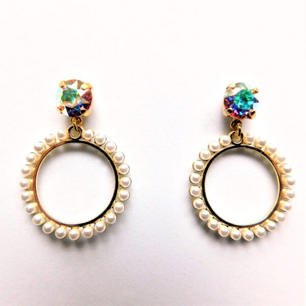 A pair of earrings with pearls and a rainbow stone.