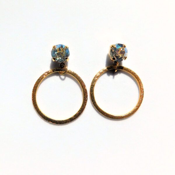 A pair of earrings with blue stones on them.