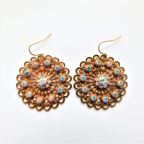 A pair of earrings with gold and blue beads.