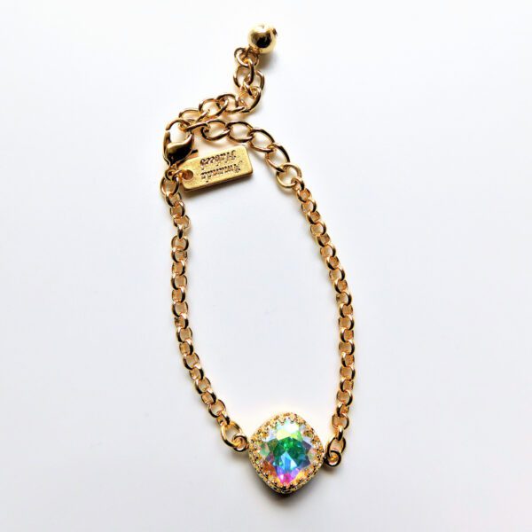 A gold chain bracelet with a round crystal.