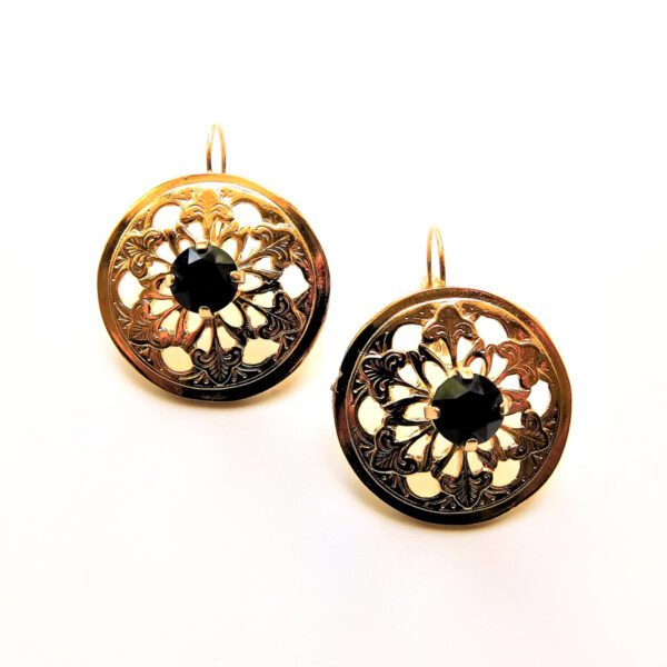 A pair of gold earrings with black stone.