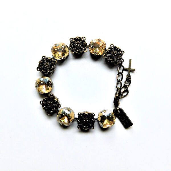 A bracelet with black and gold stones on it