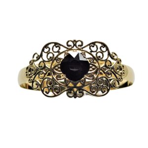 Gold bracelet with ornate design and black gem.