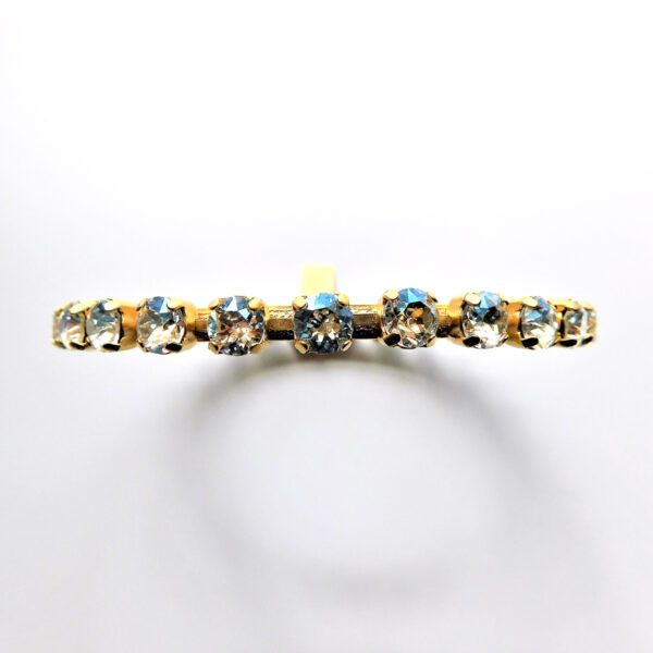 A gold ring with blue stones on it.