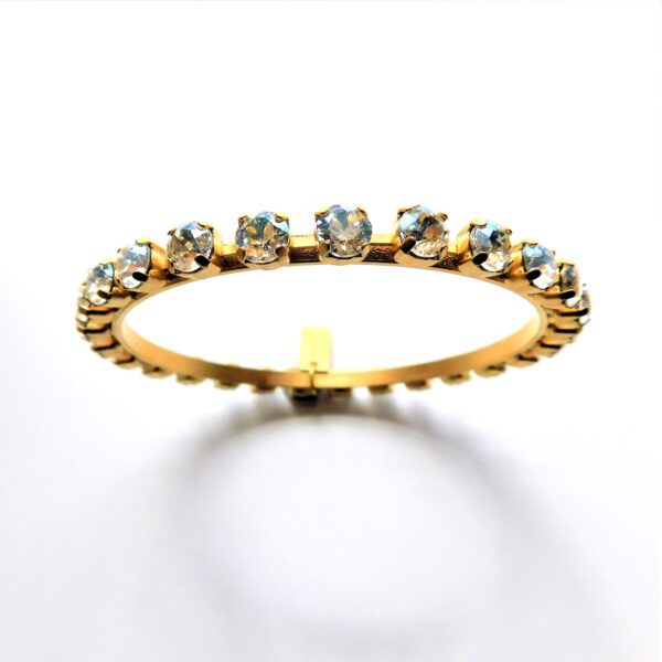 A gold ring with a row of diamonds on it.