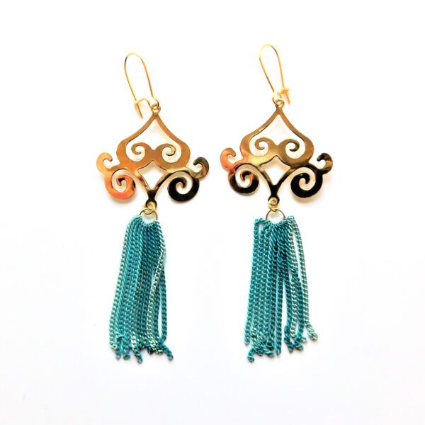 A pair of earrings with blue tassels hanging from them.