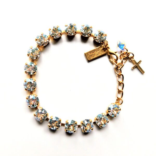 A gold bracelet with a cross charm and crystal stones.