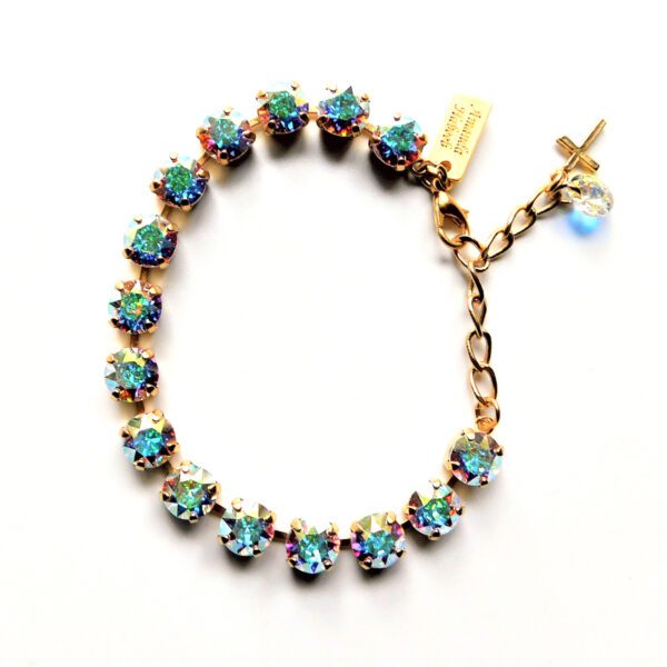 A bracelet with blue and green stones on it.