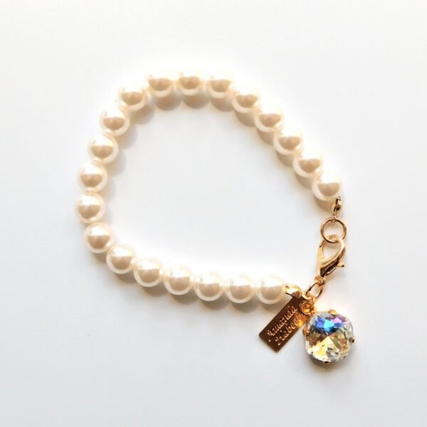 A bracelet with pearls and a crystal charm.