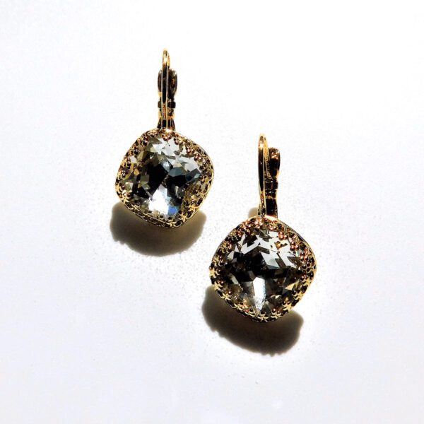 A pair of earrings with gold and white stones.