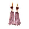 A pair of earrings with long chains and heart shaped stones.