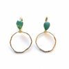 A pair of earrings with green stones hanging from them.