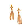 A pair of gold earrings with chains and leaves.