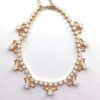 Elegant gold and crystal necklace design.