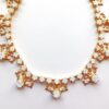 Elegant gold and crystal necklace design.