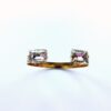 Two stone gold ring on white background.