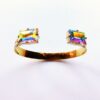 Gold bracelet with colorful gemstone accents.