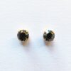 Black gemstone earrings with gold settings.