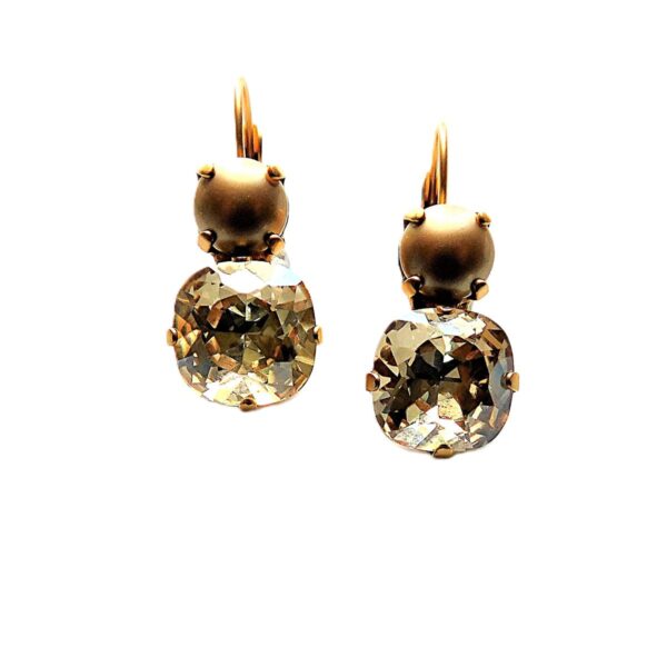 Gold and crystal drop earrings on white background.