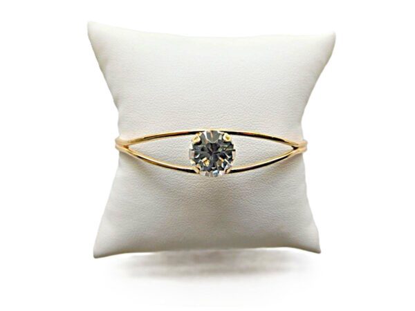 Gold ring with a large diamond centerpiece.
