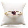 Gold ring with a round gemstone display.