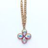 Gold chain necklace with jeweled flower pendant.