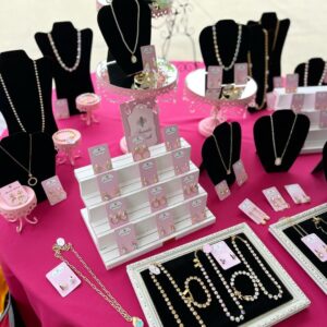 Boutique jewelry display on pink tablecloth
