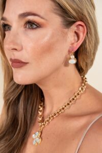 Close-up of woman with gold necklace and earrings