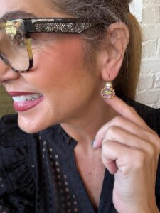 Smiling woman adjusting rhinestone hoop earring